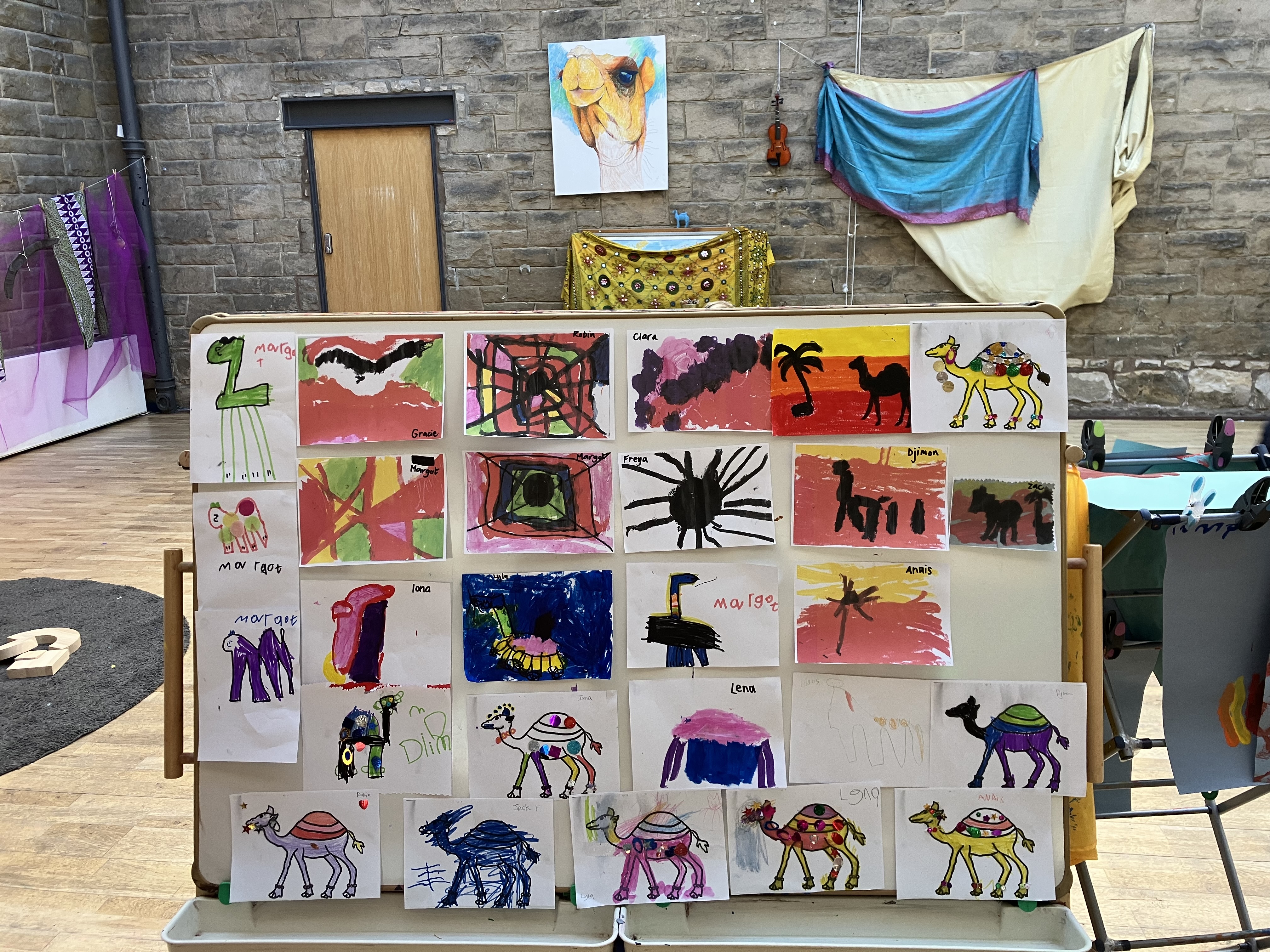 Display board showing children's artwork at Greenbank Preschool