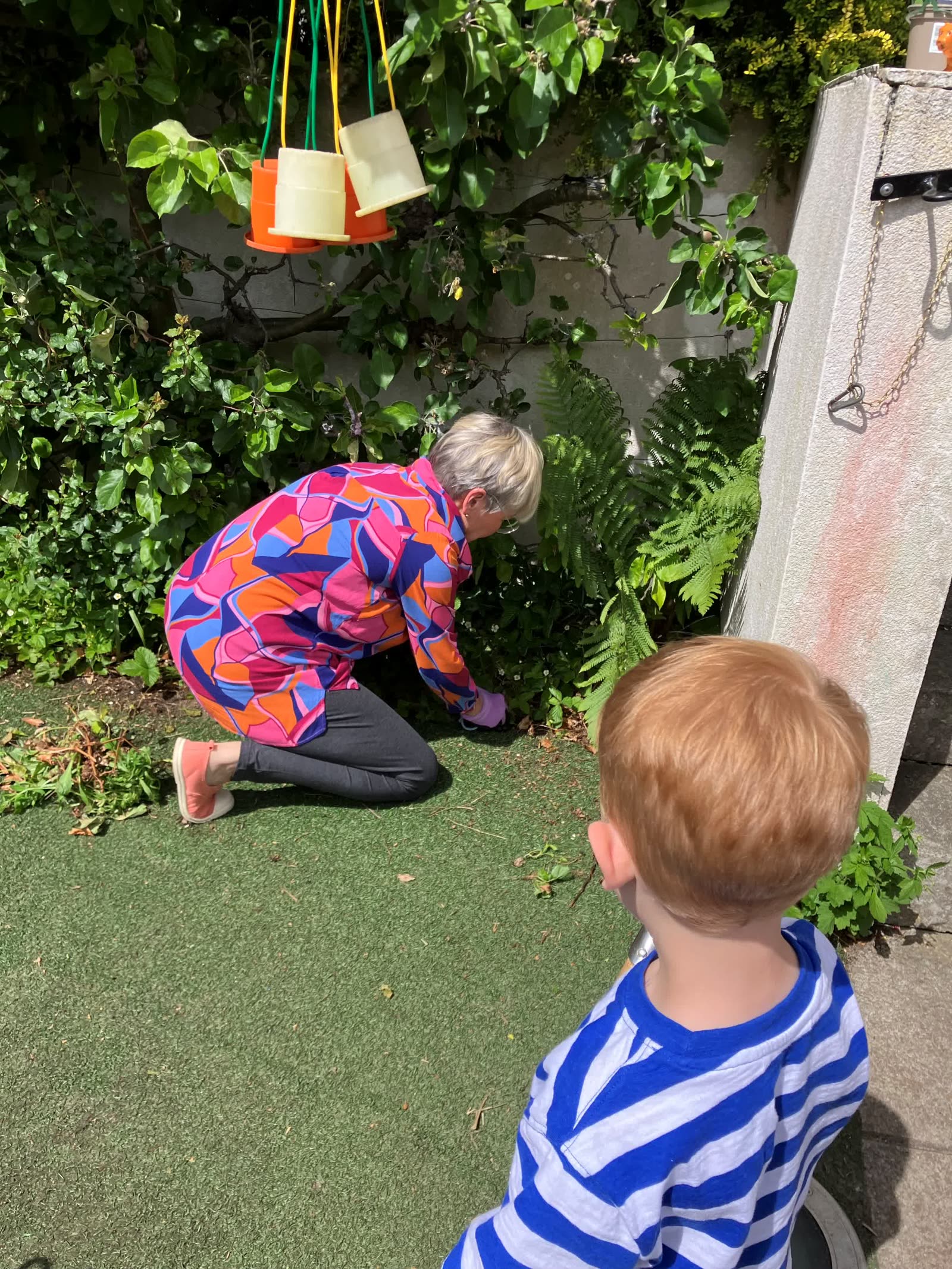 A staff member and child digging in the Pocket Picnic Garden