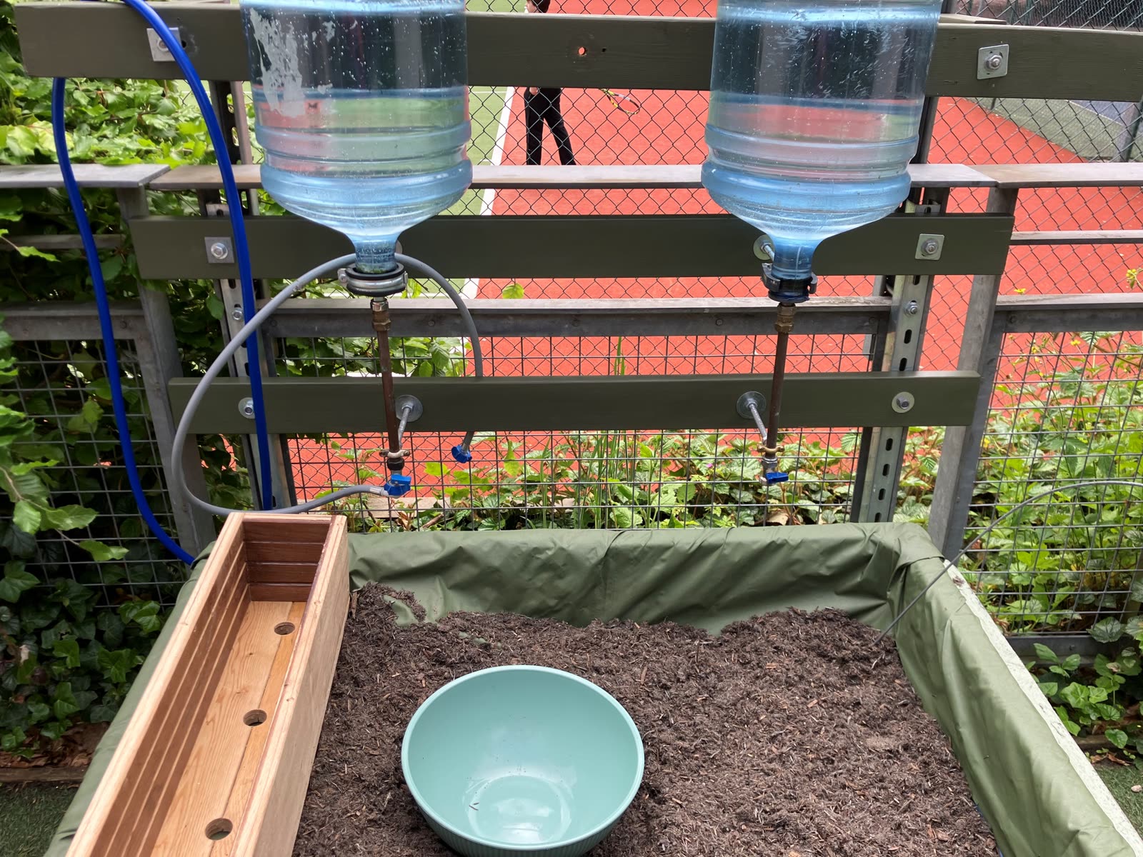 The Pocket Picnic Garden bed early on, with the water collectors newly installed