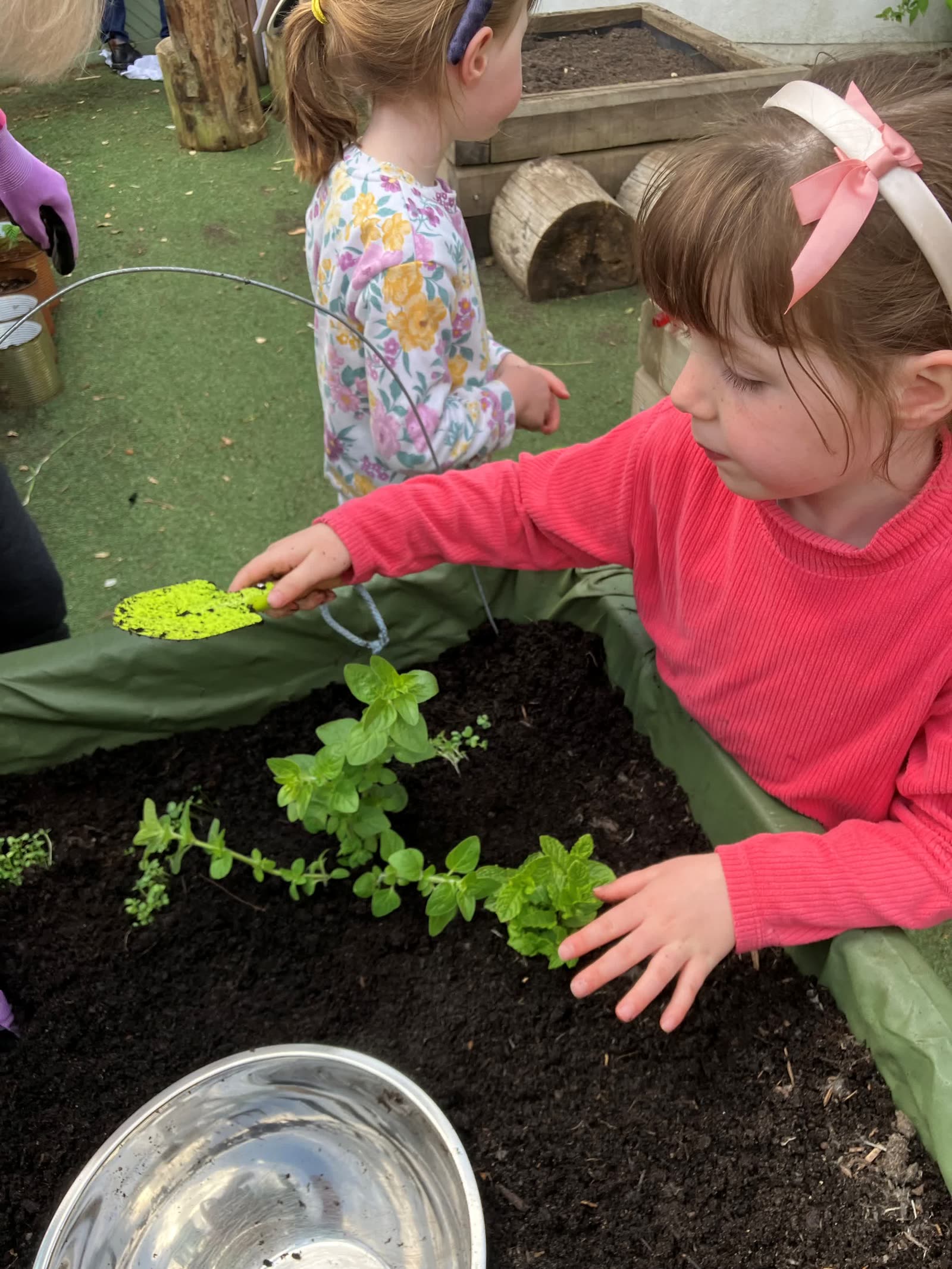 A child planting seedlings in the Pocket Picnic Garden