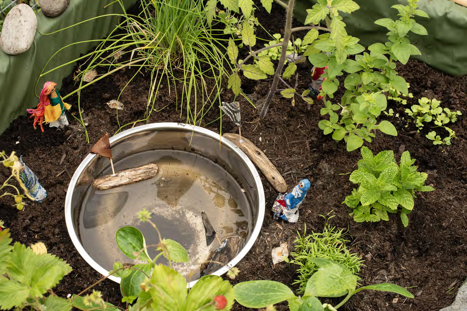 The minibeast pond in the Pocket Picnic Garden with small figures