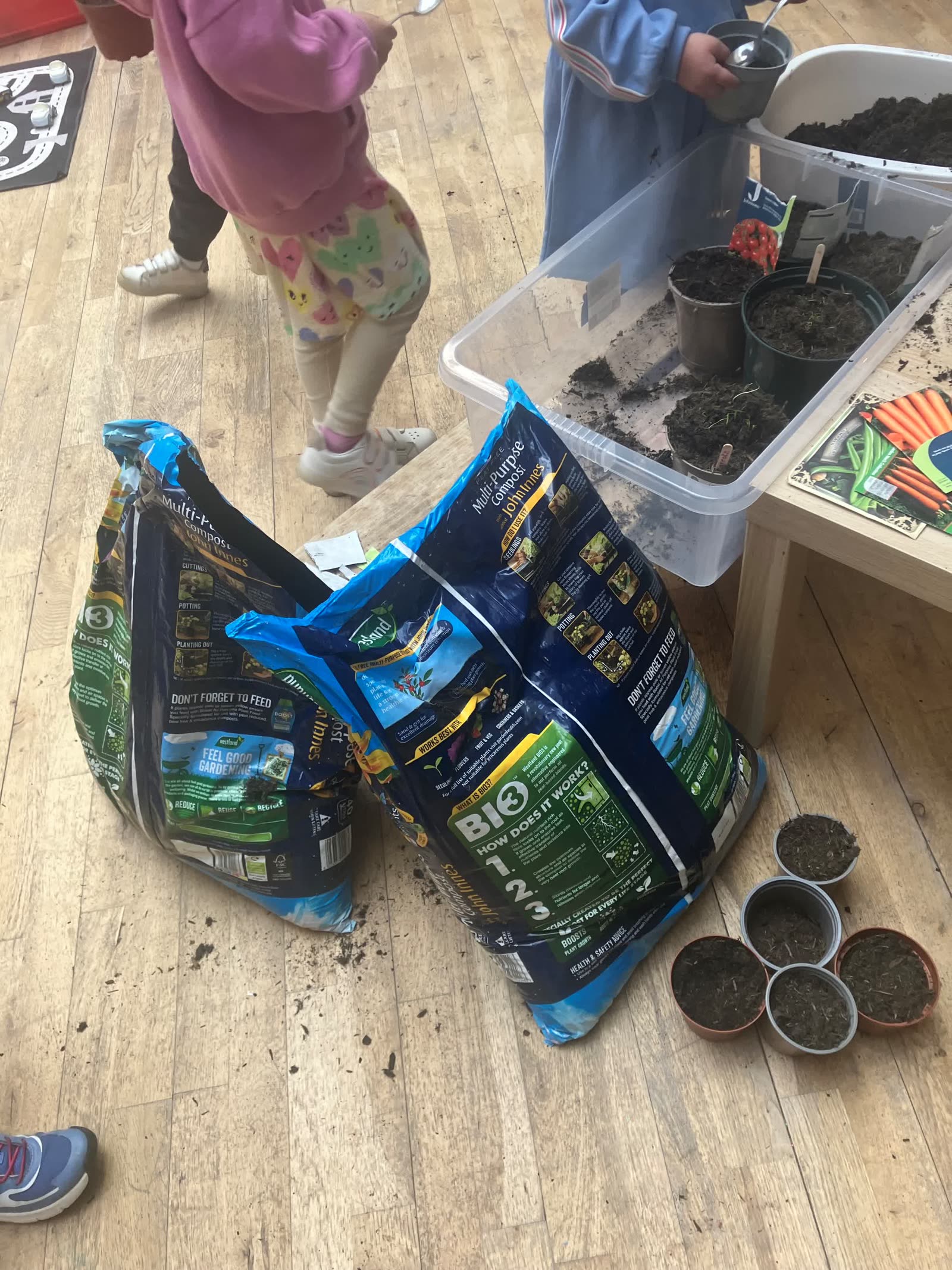 Children potting soil together for the Pocket Picnic Garden